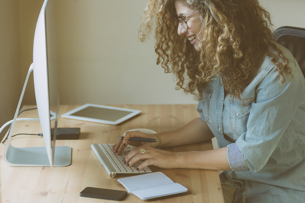 Woman using a computer smiling