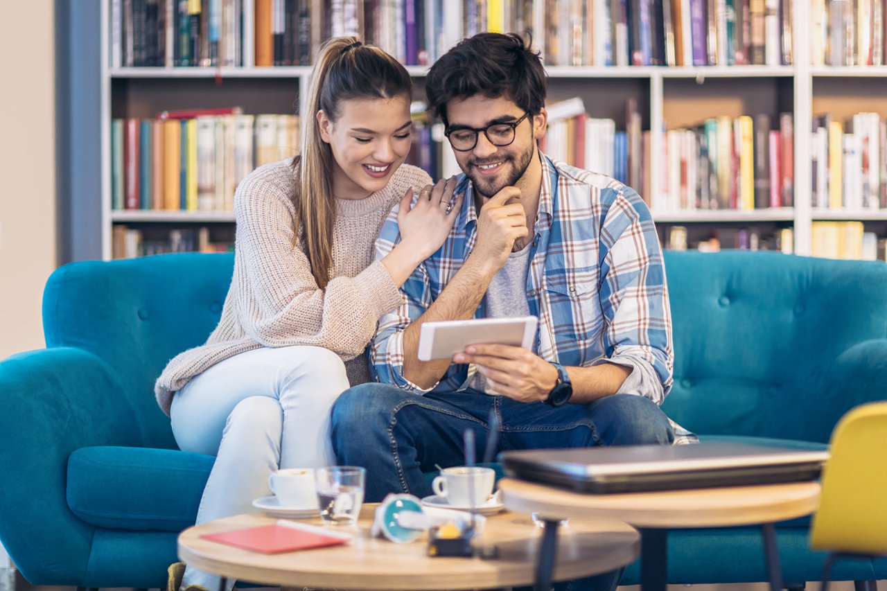 young man and woman looking at information on a cellphone